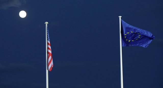 EU and US flags seen beneath the moon EU and US flags seen beneath the moon